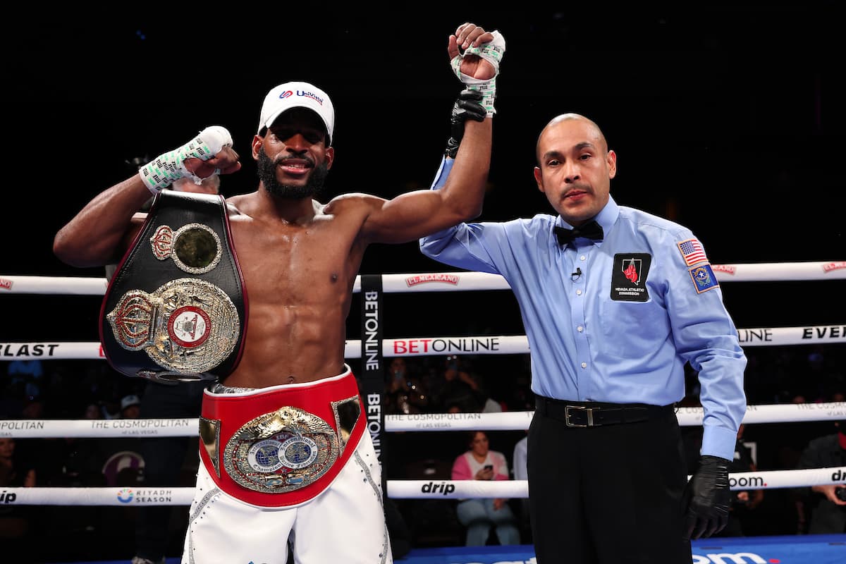 Referee Raul Caiz Jr raises boxer Andy Cruz's hand in victory