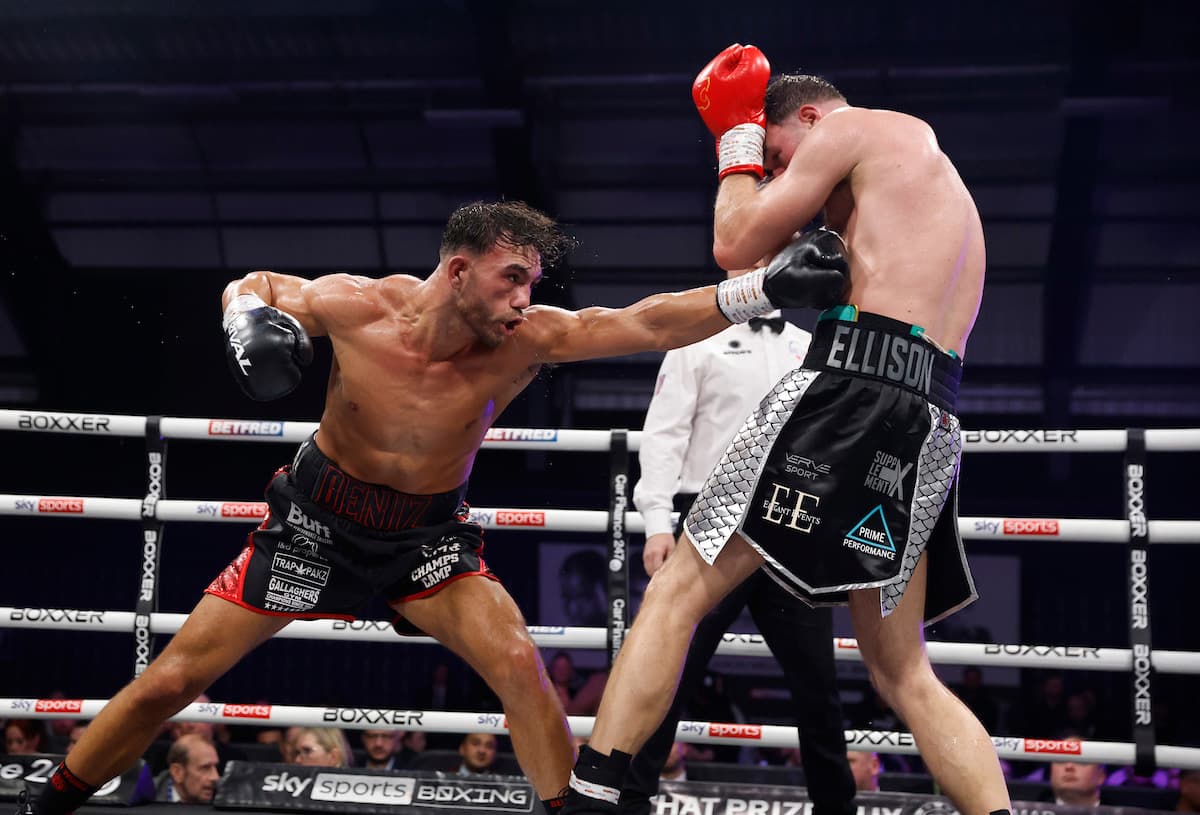 Billy Deniz throws a body jab in his bout against Mickey Ellison