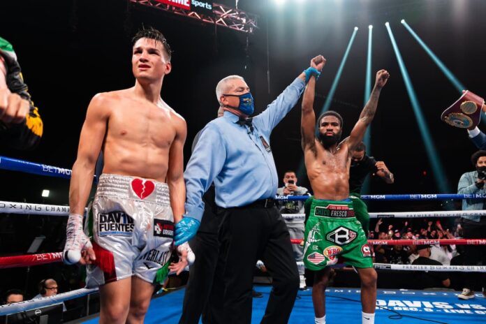 Stephen Fulton has his hand raised as he takes victory over Brandon Figueroa