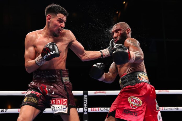 Diego Pacheco lands a left hook in his bout against Steven Nelson