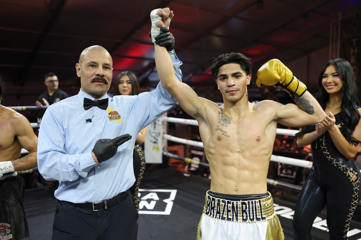 Referee Ivan Guillermo raises boxer Jordan Fuente's hand in victory