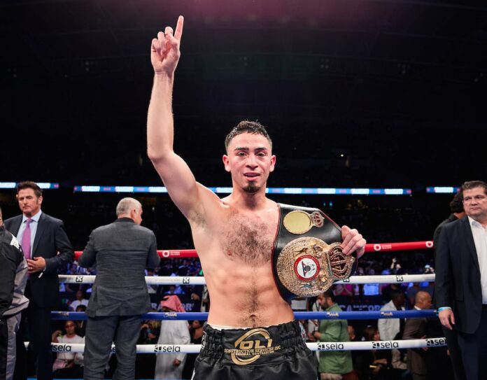 Boxing champion Jose Valenzuela poses with his WBA title belt