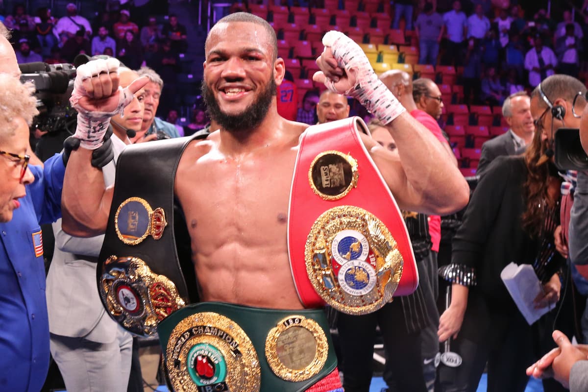 Boxer Julian Williams poses with his championship belts