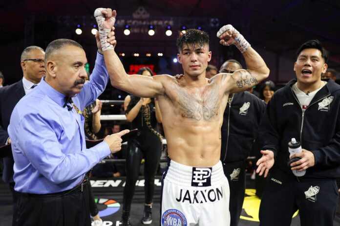 Referee Ray Corona raises Eric Priest's hand in victory