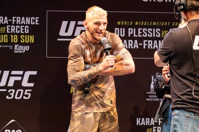 Dan Hooker holds the mic during UFC 305 public workout