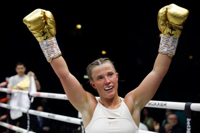 Francesca Hennessy raises her hands in victory after the boxing match