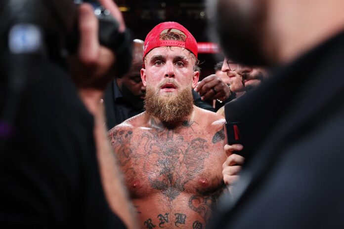 Jake Paul wears a red cap during his boxing match against Mike Tyson