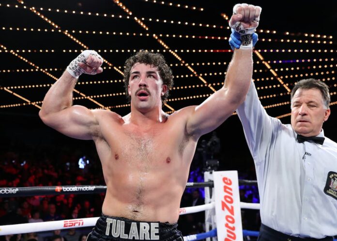 Richard Torrez Jr raises his hands in victory after his boxing match against Ahmed Hefny