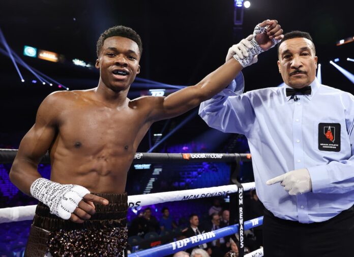 Referee Tony Weeks raises Abdullah Mason's hand in victory after his win over Luciano Ramos