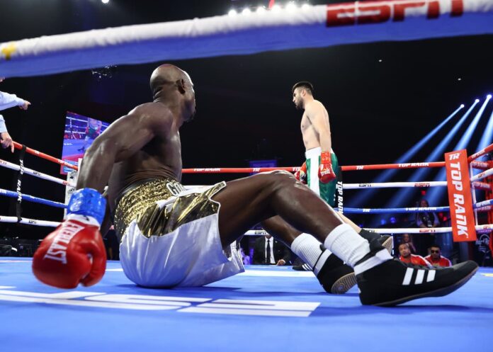 Bakhodir Jalolov knocks down Onoriode Ehwarieme during their boxing bout