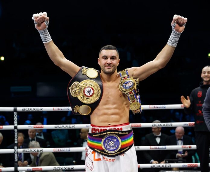 Callum Simpson celebrates his victory in a boxing match against Elvis Ahorgah