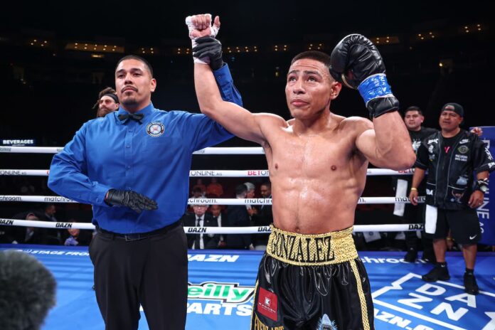 Referee Joey Chavez raises Albert Gonzalez's hand in victory over Alexis Eduardo Molina