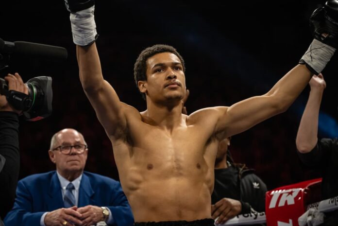 Wilkens Mathieu raises his hands during his boxing fight